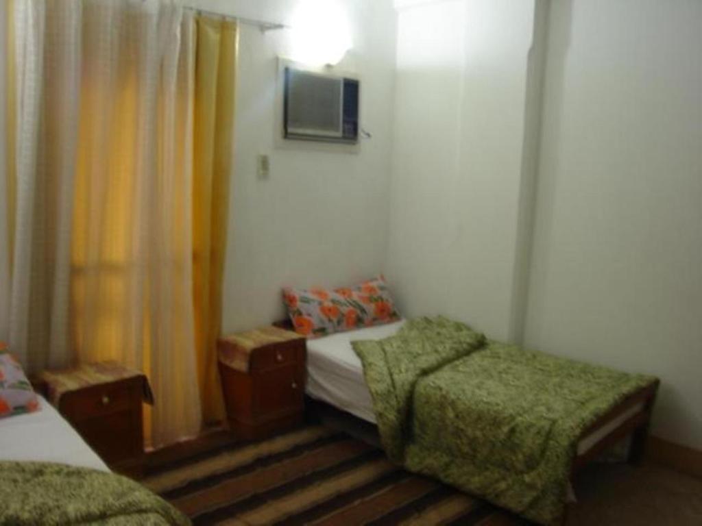Postel nebo postele na pokoji v ubytování Rose Guest House