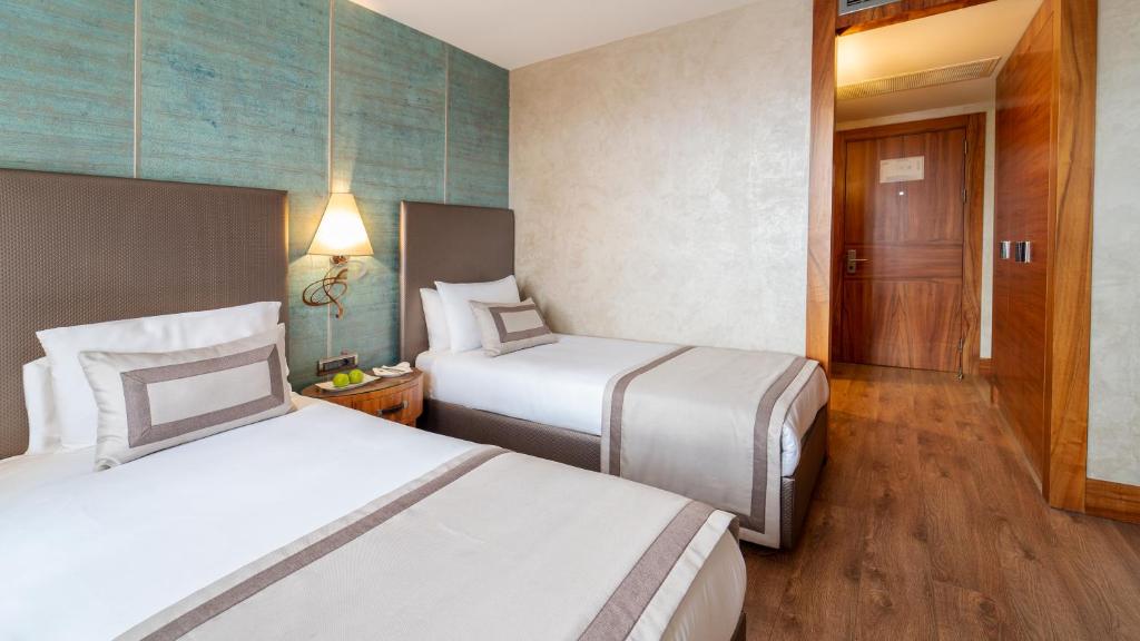 Postel nebo postele na pokoji v ubytování Biz Cevahir Hotel Sultanahmet