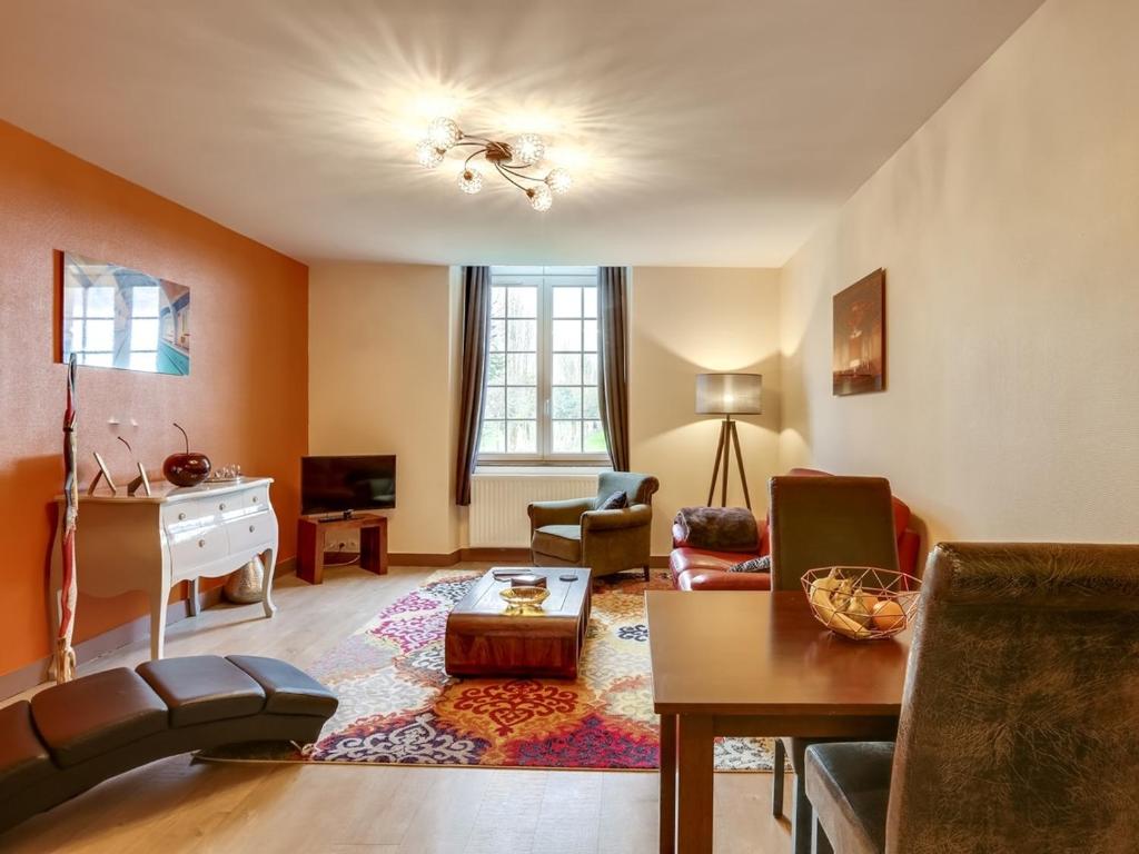 a living room with a couch and a table at Le Seigneur de Bons in Bons-Tassily