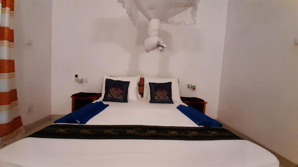 Postel nebo postele na pokoji v ubytování The Otunna Guest House Sigiriya