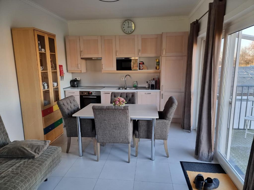 a kitchen with a table and chairs in a room at Guest House Scheldevallei in Merelbeke