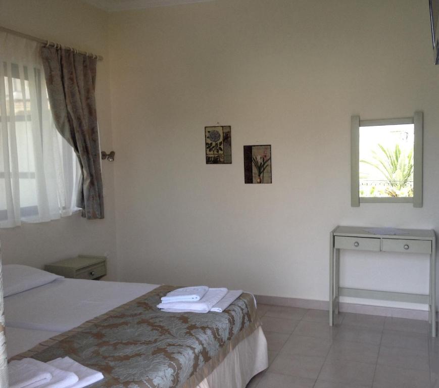 Postel nebo postele na pokoji v ubytování Yasemi Rooms