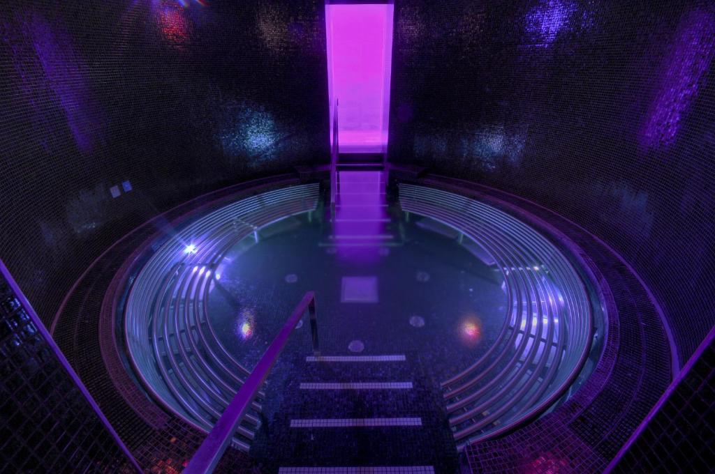 an overhead view of a pool of water with purple lights at Kimpton Blythswood Square Hotel & Spa by IHG in Glasgow