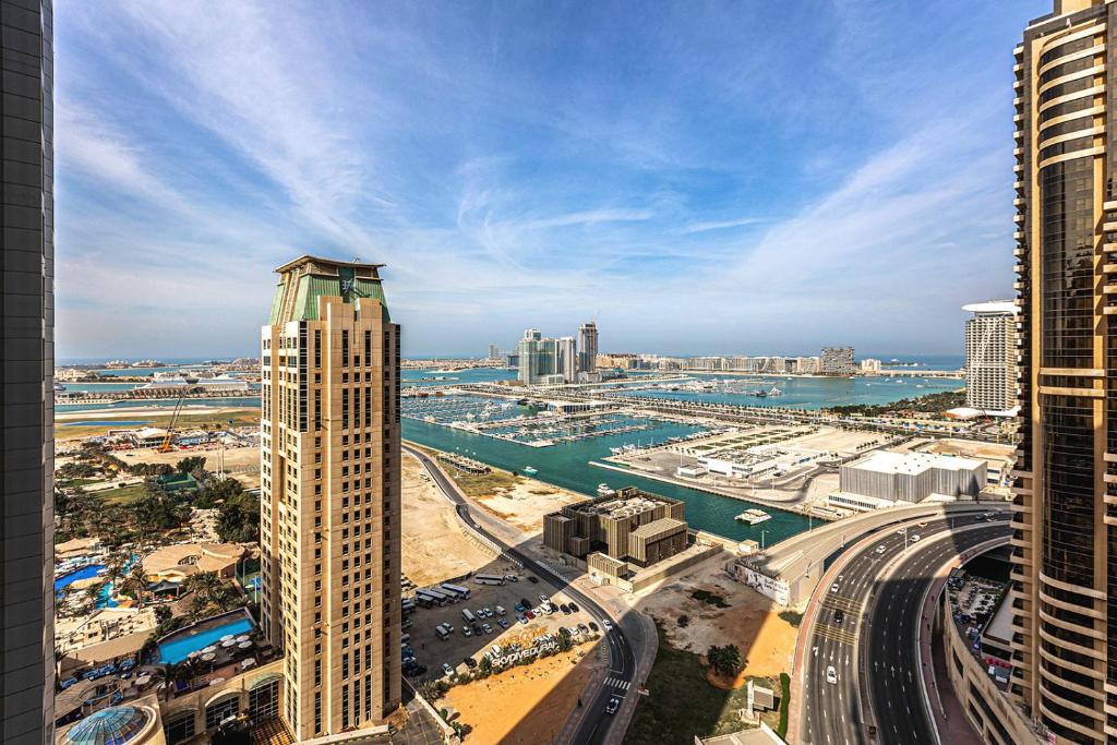 a view of a city with a tall building at Botanica Tower, Dubai Marina in Dubai