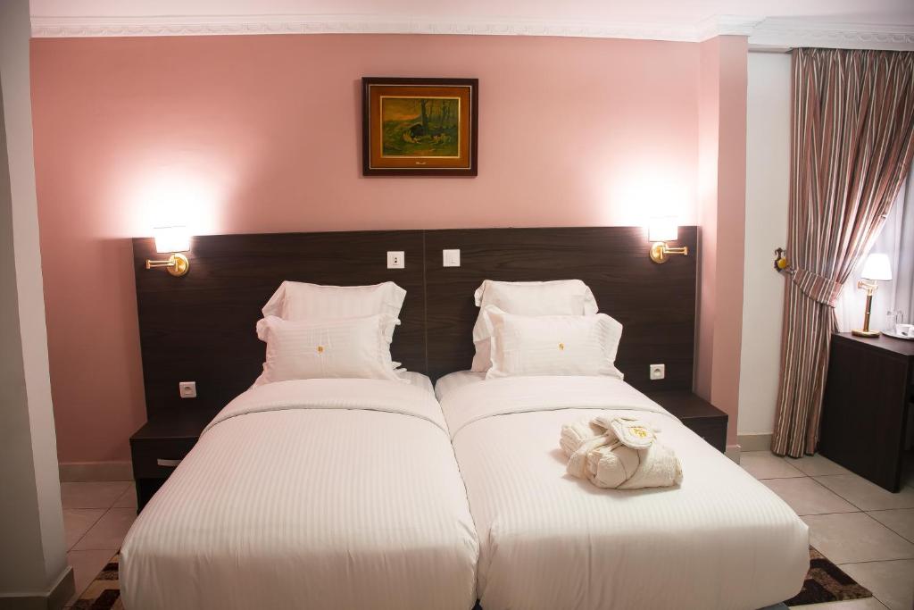 Postel nebo postele na pokoji v ubytování FAYA Hotel