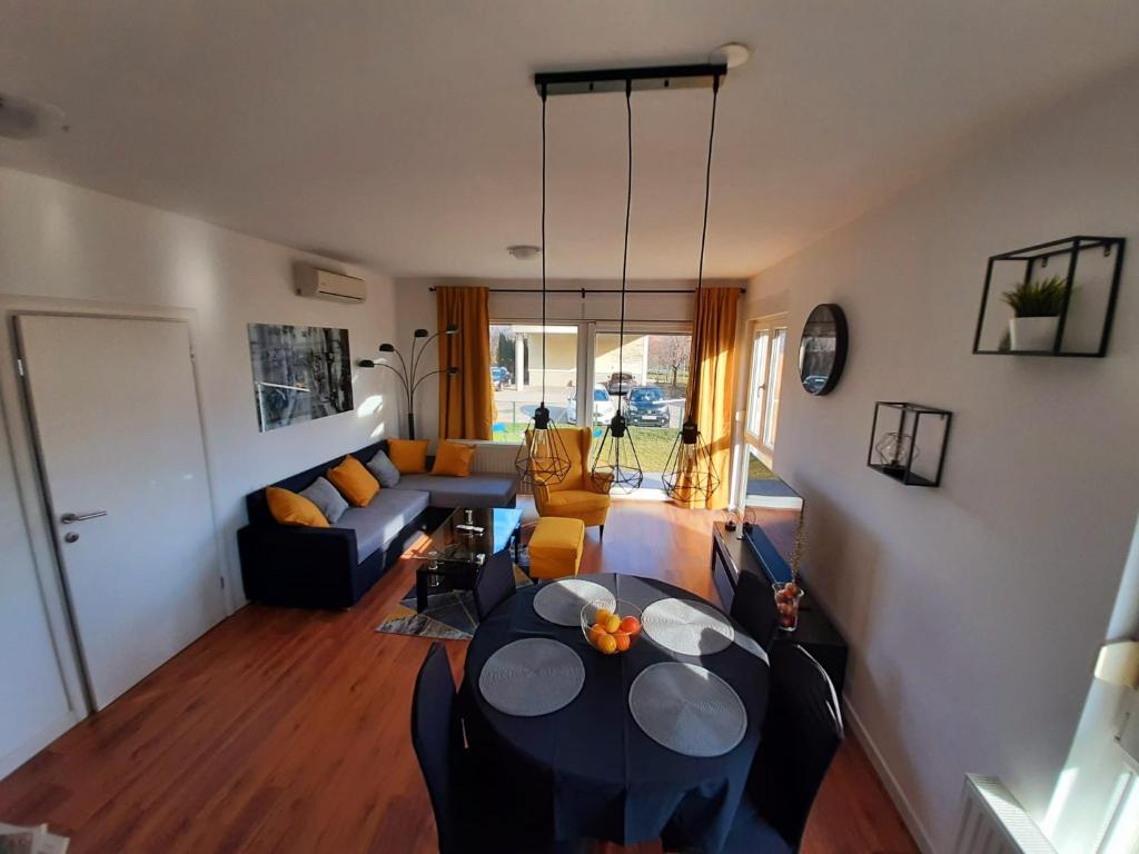 a living room with a couch and a table at Apartman EVA ZAGREB in Zagreb