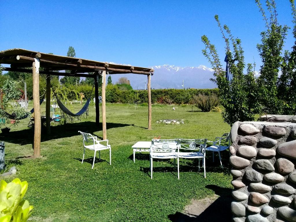 a patio with a table and chairs and a swing at Cabana Mamull in La Consulta
