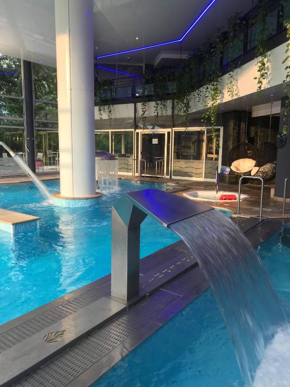 una piscina con una fuente en un edificio en Hotel &amp; Spa Marina d&#39;Adelphia, en Aix-les-Bains