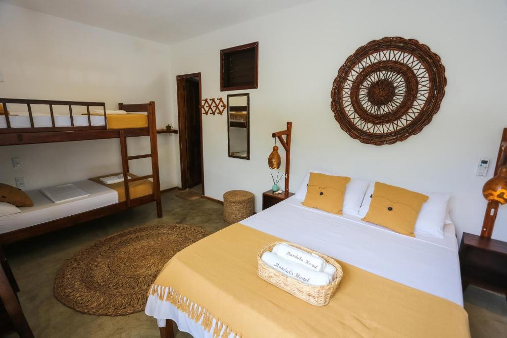a bedroom with a bed with a basket on it at Mandala Hostel Jeri in Jericoacoara