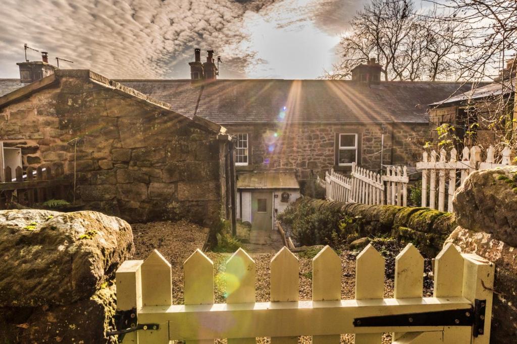 a white picket fence in front of a house at Finest Retreats - Tring-on-Tor in Matlock