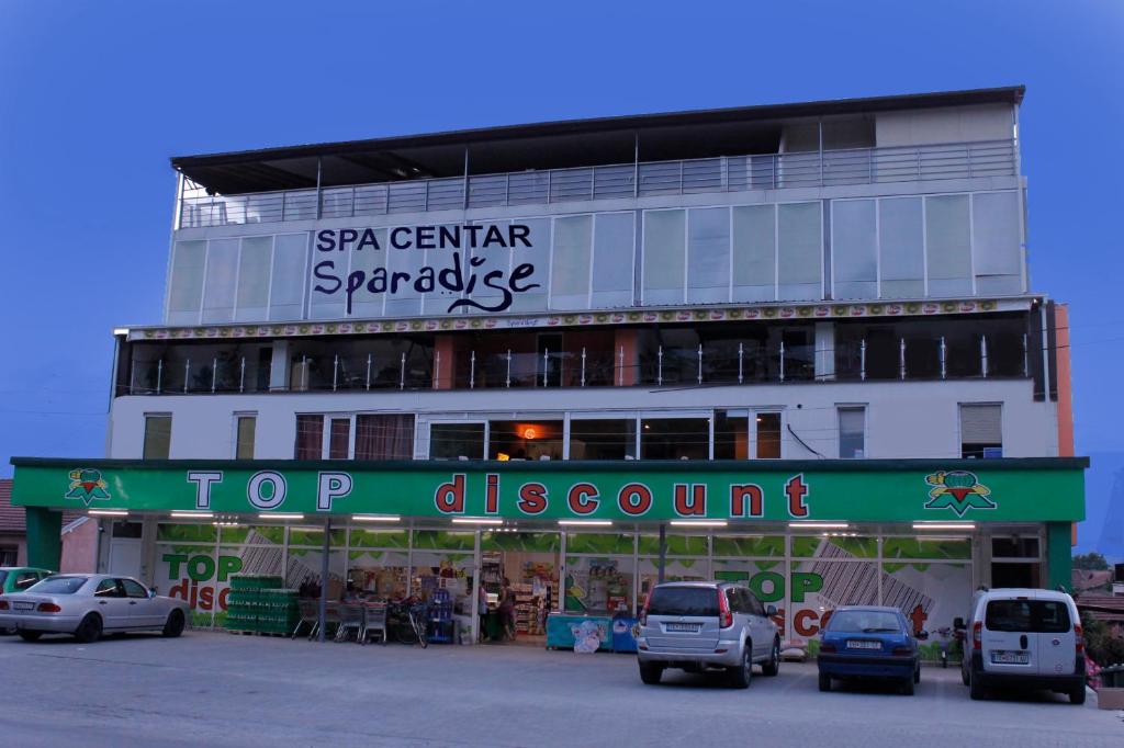 a building with cars parked in a parking lot at Villa Sparadise in Ohrid