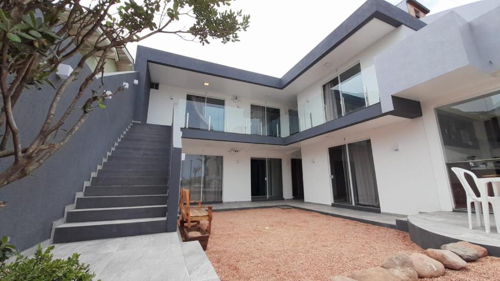 an image of a house with a staircase at Morada Summer Beach Beira Mar in Tramandaí