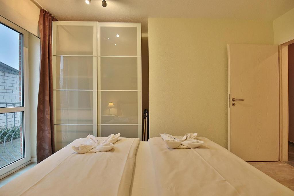 Postel nebo postele na pokoji v ubytování Gorch-Fock-Straße 16 Gorch-Fock-Str 16 Appartement 1
