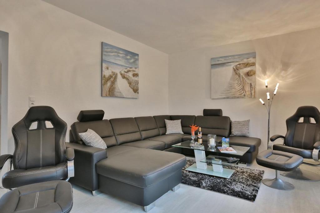 ein Wohnzimmer mit einem Sofa und 2 Stühlen in der Unterkunft Residenz Strandnah Residenz Strandnah Haus in Haffkrug