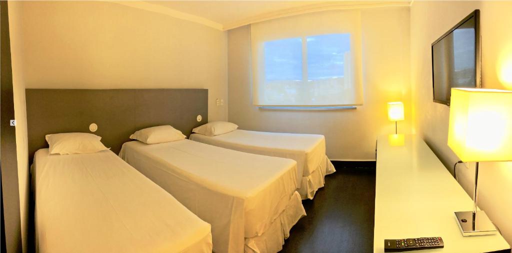 Postel nebo postele na pokoji v ubytování Hotel Gran Vivenzo Belo Horizonte