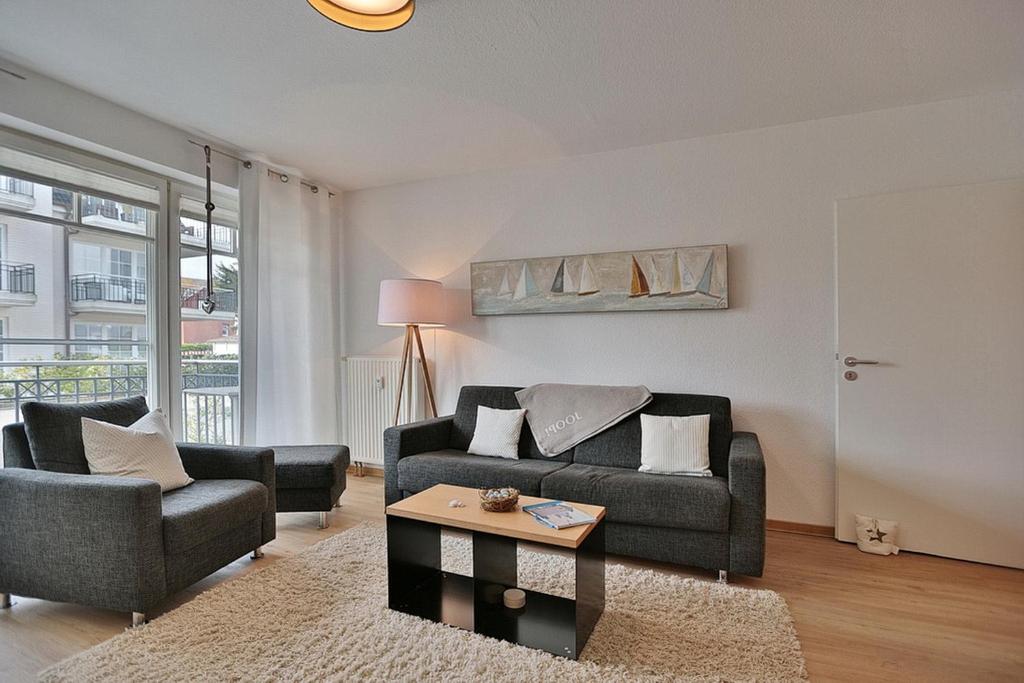 a living room with a couch and a table at Haus Strandstrasse Strandstrasse 150 Appartement 3 in Niendorf