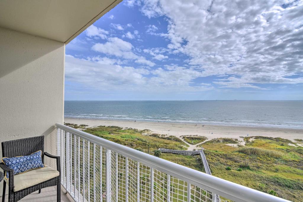 a balcony with a chair and a view of the beach at Heated Pool and Beach View Galveston Resort Condo! in Galveston