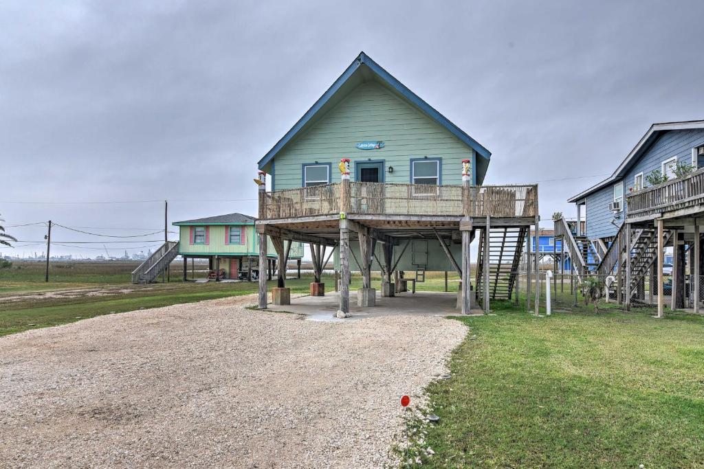 a house with a deck on top of a playground at Coastal Cottage - 4 Blocks to Surfside Beach! in Freeport