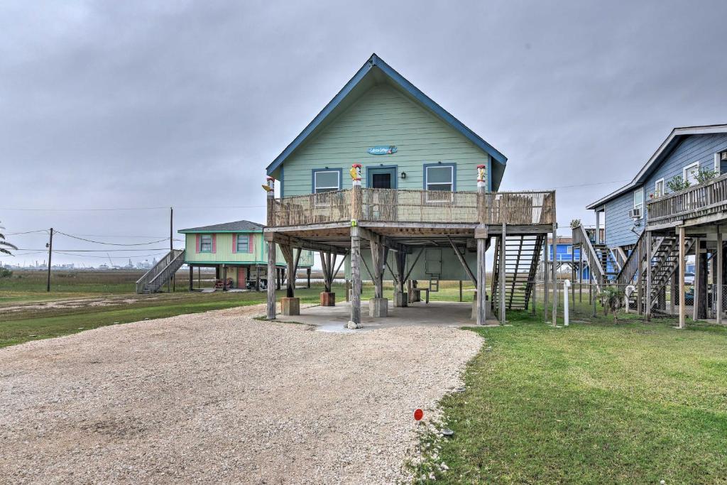 a house with a deck on top of a playground at Walk to Shore: Cottage w/ Deck in Surfside Beach! in Freeport