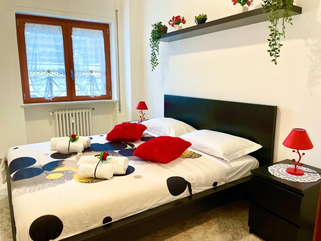 a bedroom with a bed with red pillows on it at Apartment Sant'Antonio in Bari