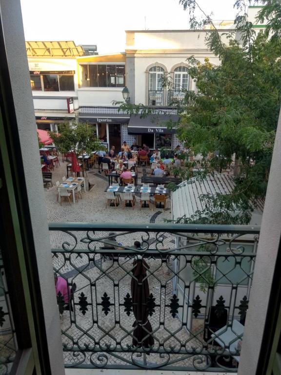a view from a balcony of a patio with tables and chairs at Casa Frajo in Fuzeta