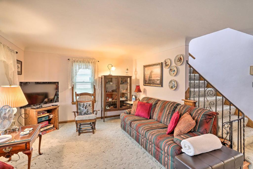 a living room with a couch and a tv at Home with Screened-In Porch Less Than 1 Mi to Lake Erie in Port Clinton