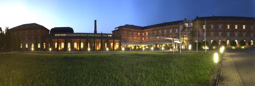 a large building with lights in front of it at nestor Hotel Stuttgart-Ludwigsburg in Ludwigsburg