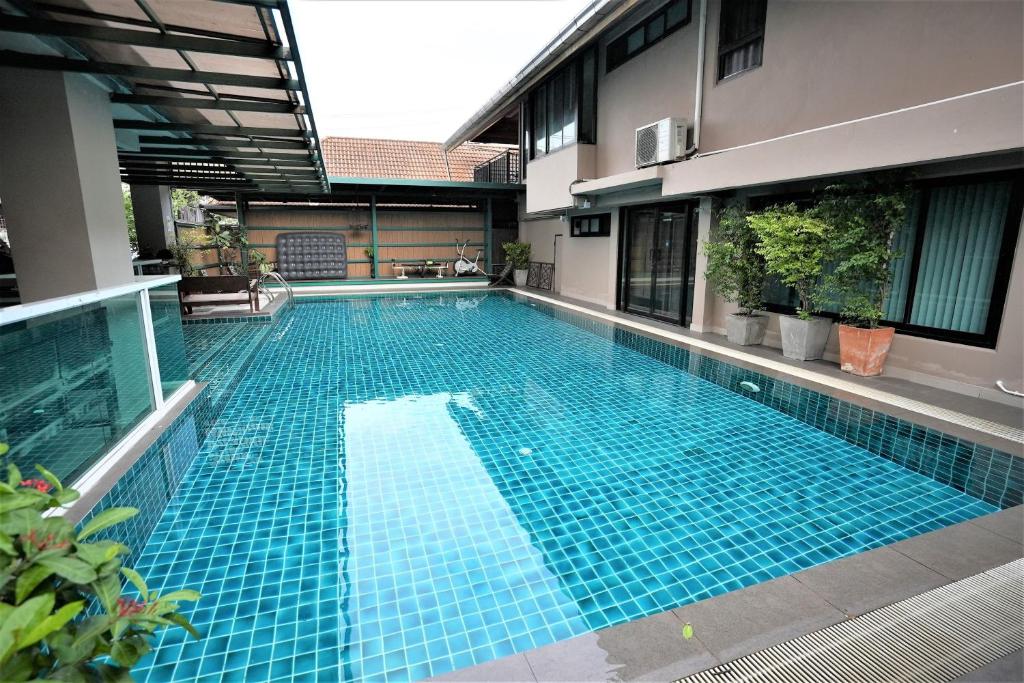 A blue-tiled outdoor pool enclosed by the hotel building.