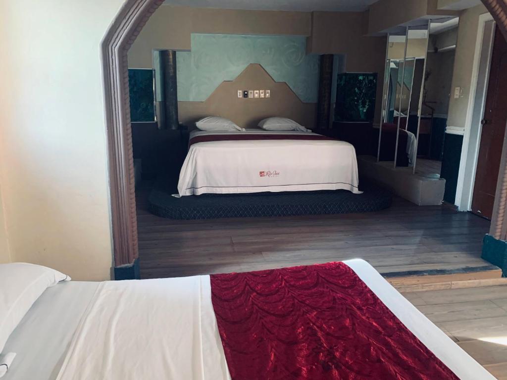 Postel nebo postele na pokoji v ubytování Hotel Rio Inn