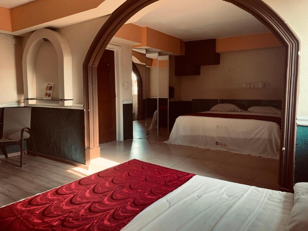 Postel nebo postele na pokoji v ubytování Hotel Rio Inn