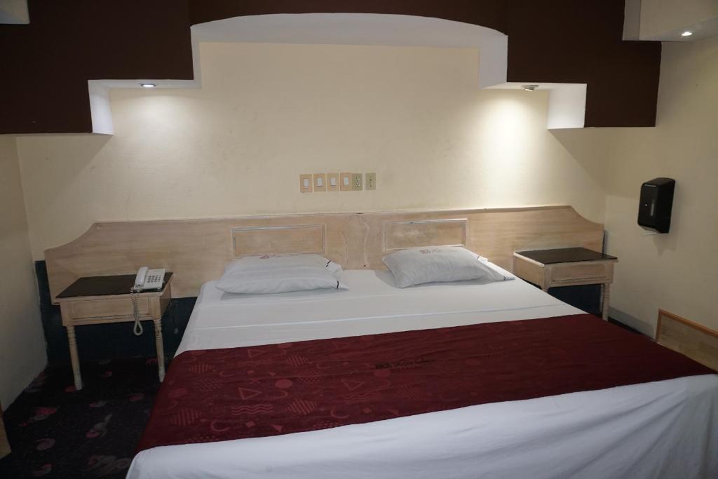 Postel nebo postele na pokoji v ubytování Hotel Rio Inn