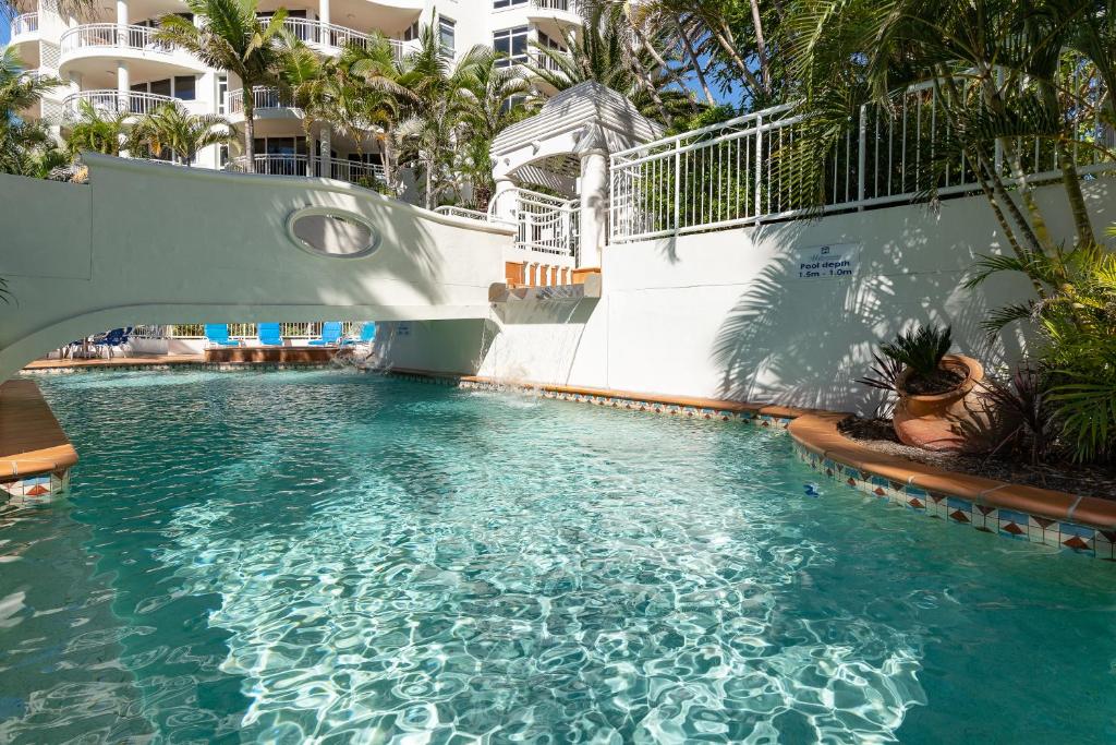a swimming pool with a slide in a resort at ULTIQA Burleigh Mediterranean Resort in Gold Coast