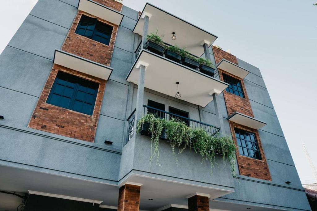 a building with windows and plants on it at Tuju Abuserin Syariah in Jakarta