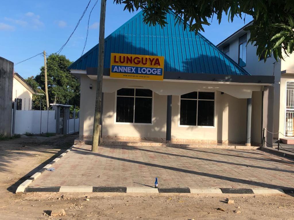 a building with a sign on the front of it at Lunguya Annex Lodge in Dar es Salaam