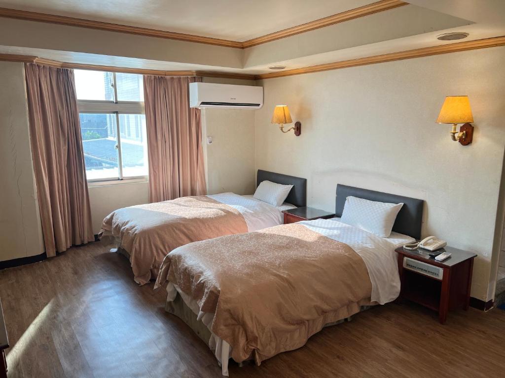 Postel nebo postele na pokoji v ubytování San Ho Business Hotel