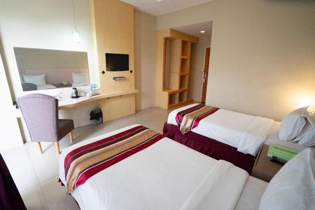 Postel nebo postele na pokoji v ubytování Bangka City Hotel