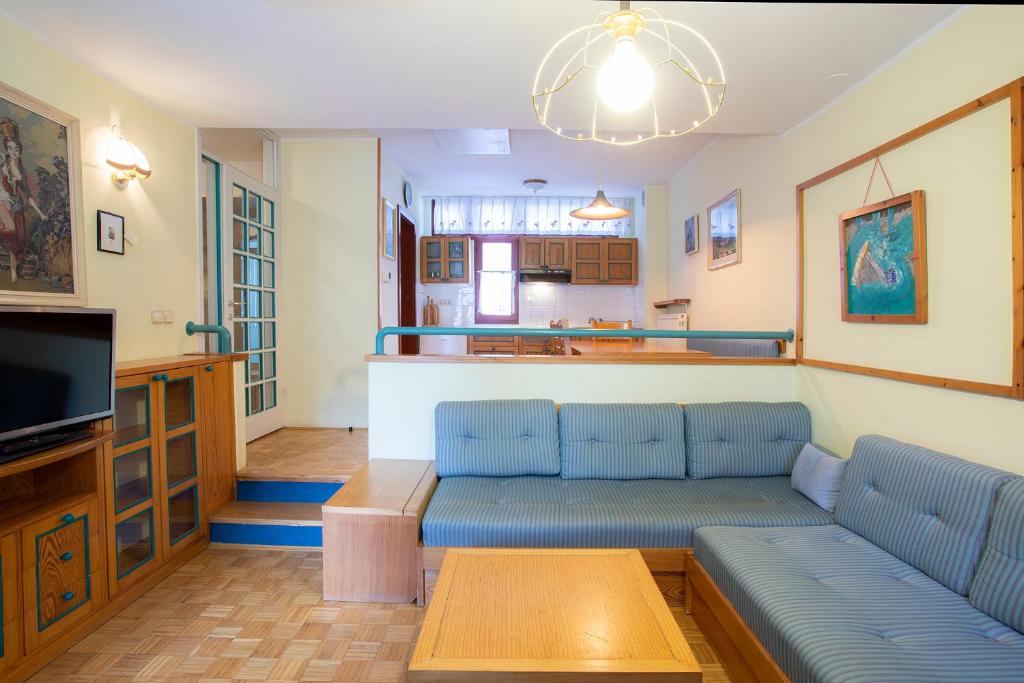 a living room with a couch and a tv at Apartments Baki Kranjska Gora in Kranjska Gora