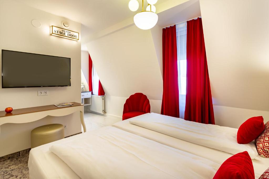 Postel nebo postele na pokoji v ubytování Theaterhotel & Suites Wien