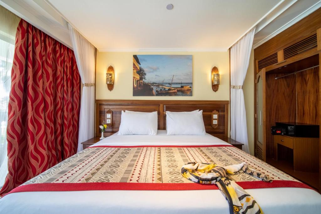 Postel nebo postele na pokoji v ubytování PrideInn Paradise Beach Resort & Spa Mombasa