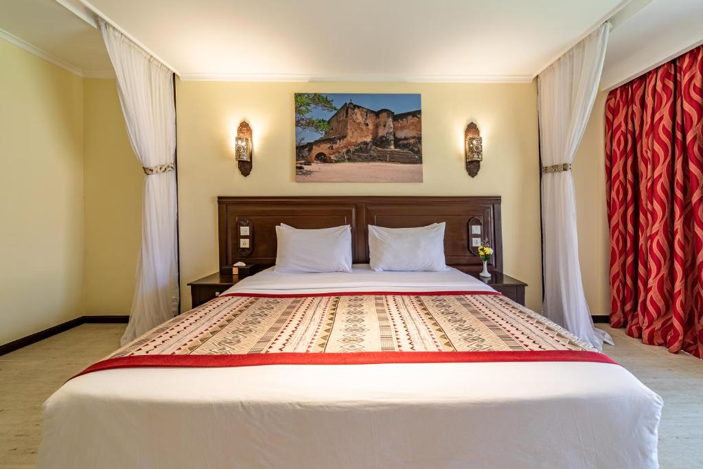Postel nebo postele na pokoji v ubytování PrideInn Paradise Beach Resort & Spa Mombasa
