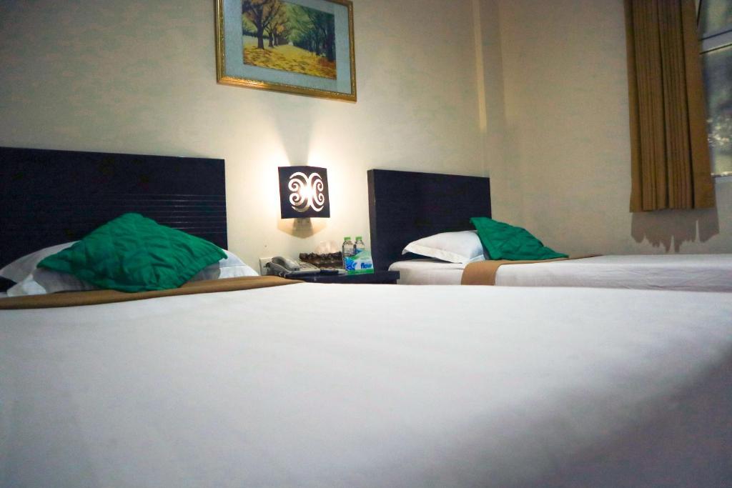 Voodi või voodid majutusasutuse Helios Hotel Malang toas