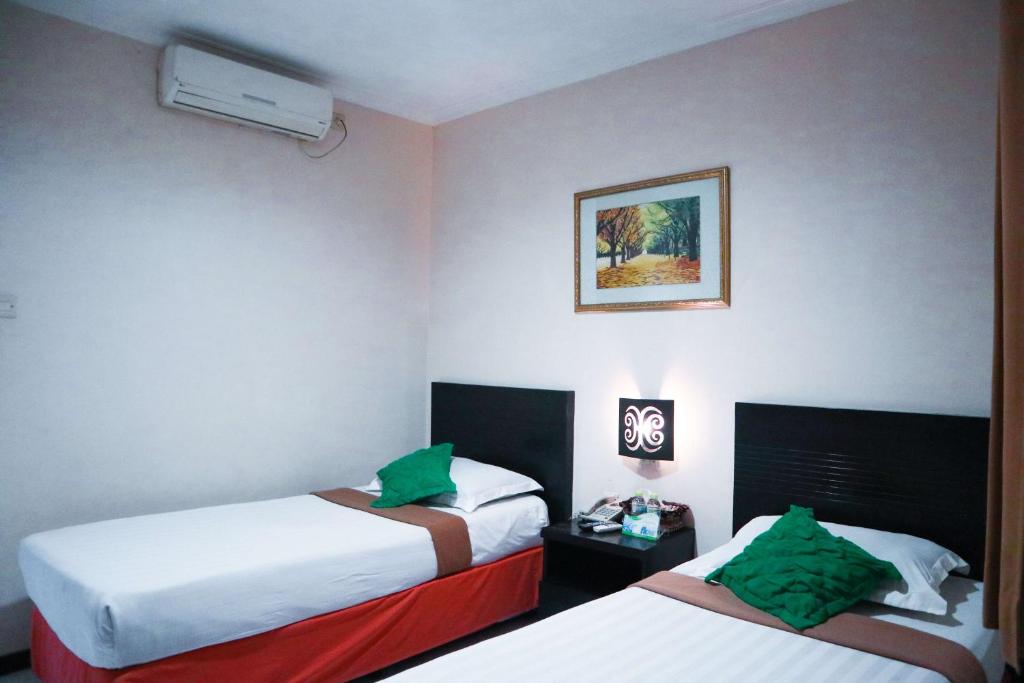 Voodi või voodid majutusasutuse Helios Hotel Malang toas