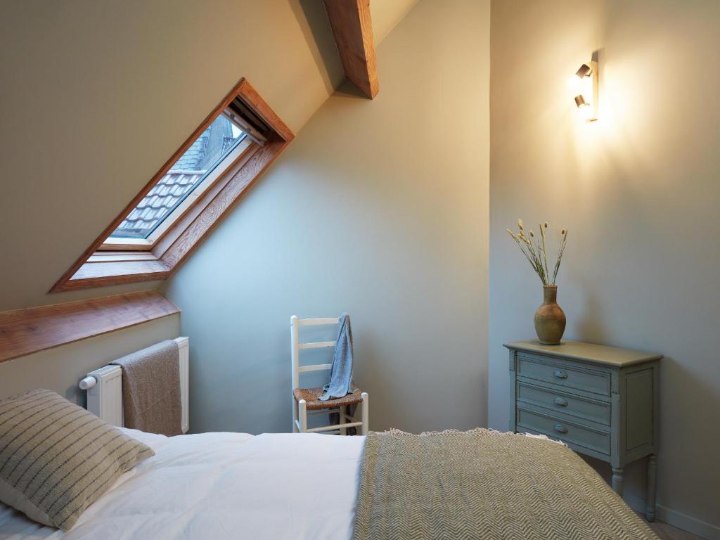Un ou plusieurs lits dans un hébergement de l'établissement La Petite Histoire gîtes-appartements