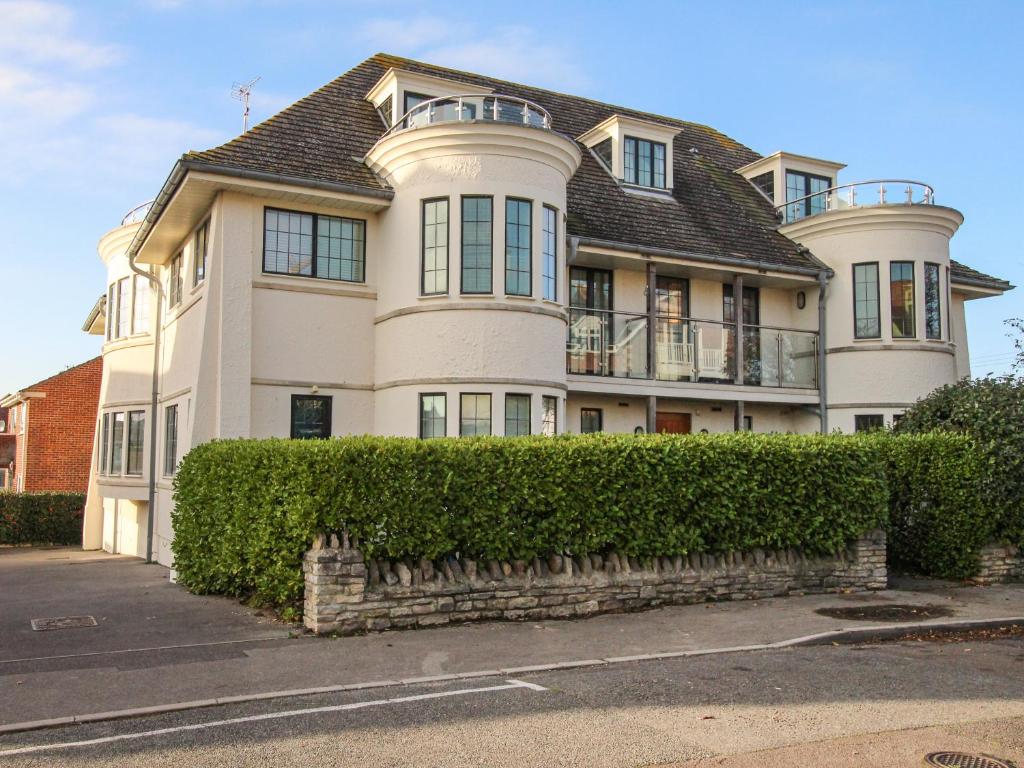 a large white house with a roof at Broad Leys in Swanage