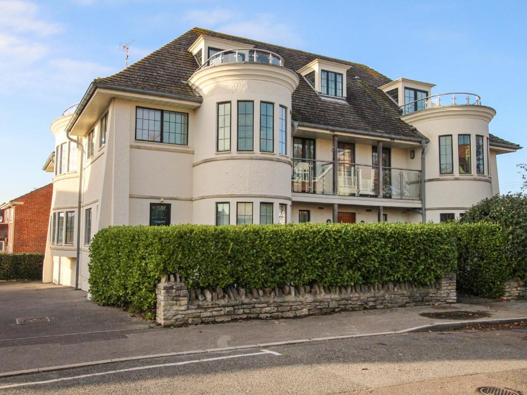 a large white house with a roof at Broadleys in Swanage