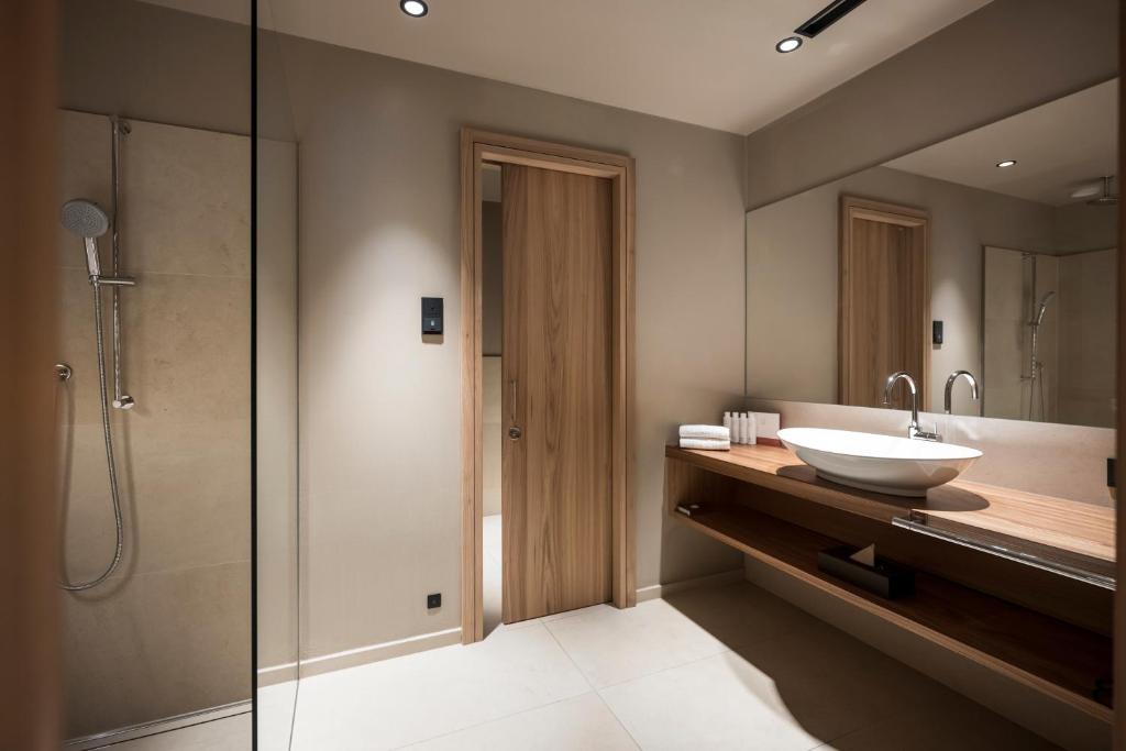 a bathroom with a sink and a shower at Adler Spa Resort Dolomiti in Ortisei