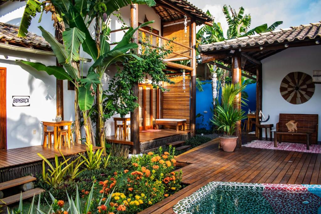 a house with a wooden deck and a swimming pool at Barra Suítes in Barra Grande