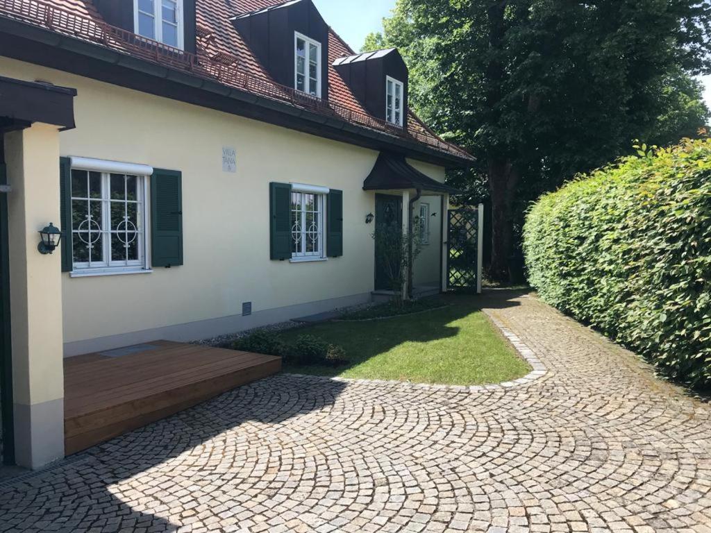 een huis met een stenen loopbrug naast een tuin bij Ferienwohnung Villa Tana Miesbach in Miesbach