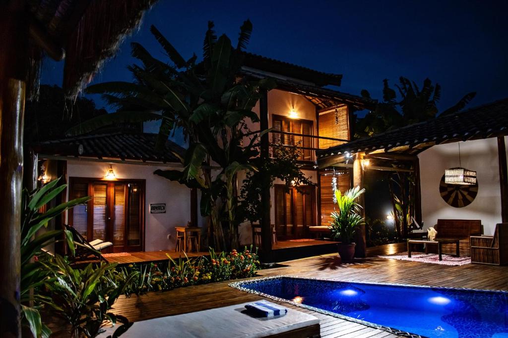 a villa with a swimming pool at night at Barra Suítes in Barra Grande