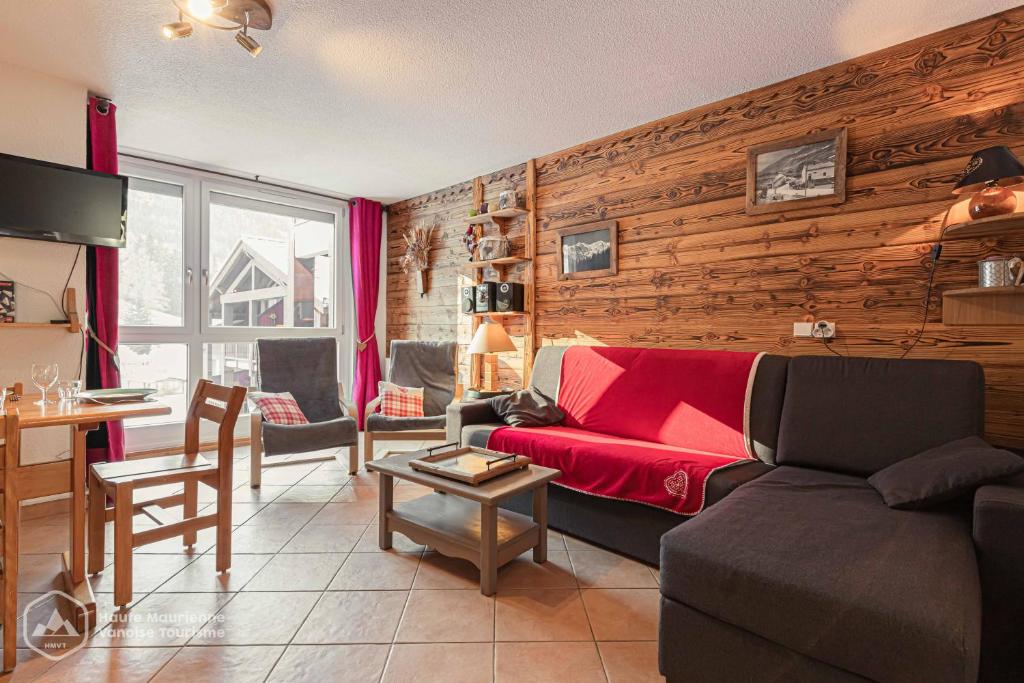 a living room with a couch and a table at Résidence Le Pied des Pistes C6 in Lanslevillard